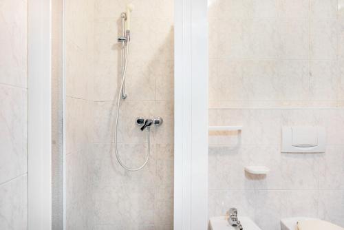 a bathroom with a shower with a toilet and a sink at Appartamenti l'Edera in Cavedago