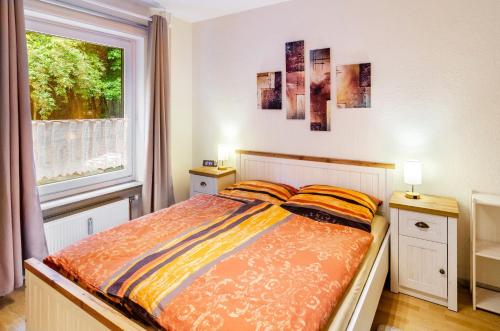 a bedroom with a bed and a window at Ferienwohnung Schmälzle in Braunlage