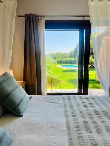 a bedroom with a bed and a window with a view at Villa Sole con piscina privata in Cuile Pazzoni