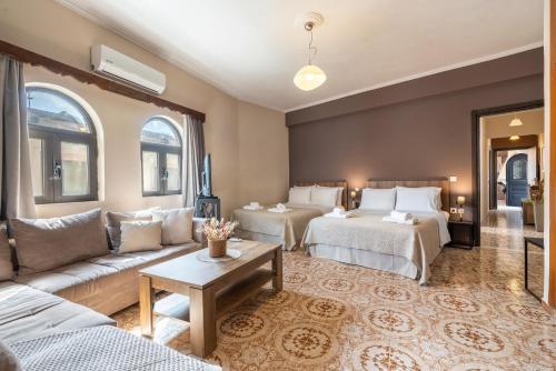 a living room with two beds and a couch at Afentika Grand Flat in Archangelos