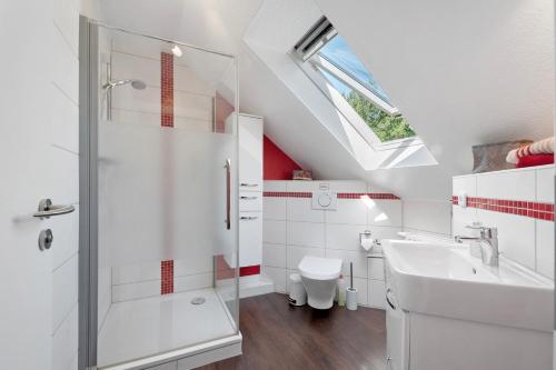a white bathroom with a shower and a sink at Fewo Birkenallee - Rose in Deinste
