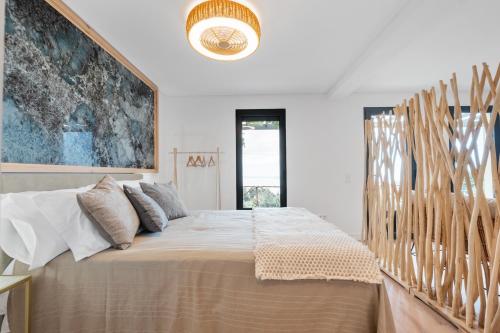 a bedroom with a large bed with a wooden headboard at Ocean View Villas in Caniço