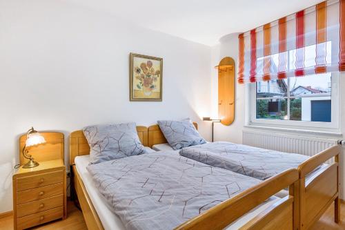 a bedroom with a bed and a window at Residenz Malscher Aue in Malsch