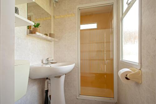 a bathroom with a sink and a shower at Oasis on the river in Marina di Pisa