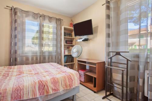 a bedroom with a bed and a flat screen tv at Chambre d'hôtes in Lorgues