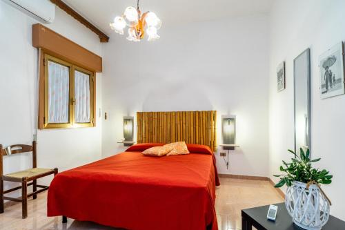 a bedroom with a red bed in a room at Villetta Lido Canne in Torre Lapillo
