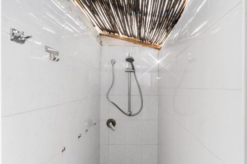 a bathroom with a shower with a shower head at Villetta Lido Canne in Torre Lapillo