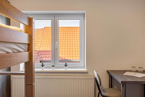 a window in a room with a desk and a table at Haus Fuldablick in Rotenburg an der Fulda