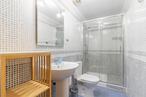 a bathroom with a toilet and a sink and a shower at Calpe Bay in Calpe