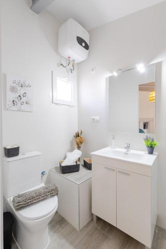 a white bathroom with a toilet and a sink at Rustic Escape by Fidalsa in Ibi