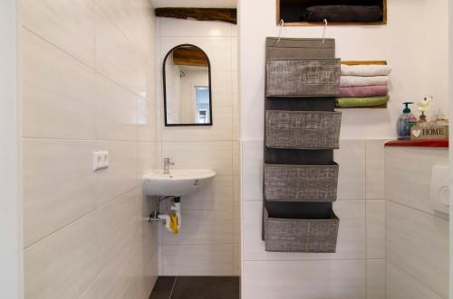 a bathroom with a sink and a mirror and towels at Lilly in Meßkirch