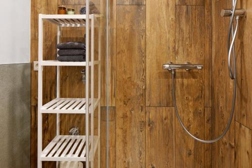 a bathroom with a shower with a wooden wall at Am Sommerrain in Elzach