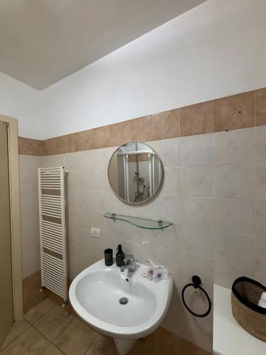 a bathroom with a sink and a mirror at La Masera sul Torrente By Immobilux in Mori