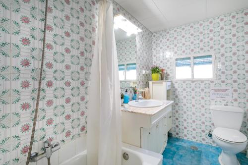 a bathroom with a toilet and a sink and a shower at La Cuina De Paqui in Caserío Calandari