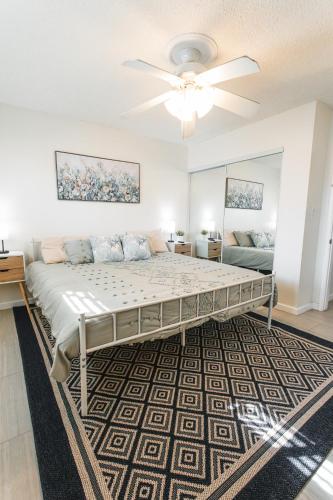 a bedroom with a large bed and a ceiling fan at 2bd Suite Steps To Beach! - Private Patio & Grill! in Oceanside
