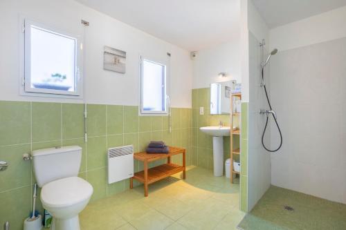 a bathroom with a toilet and a sink at La Pause Bigoudène in Penmarch