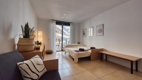 a living room with a bed and a table at Costacabana - Apartment Dali in Lloret de Mar