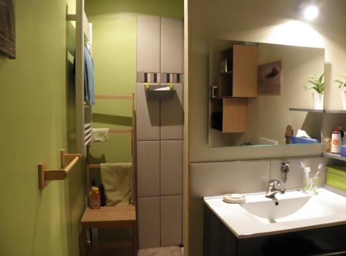 a small bathroom with a sink and a mirror at L'arbre Du Magnan - Gîte En Ardèche in Chandolas