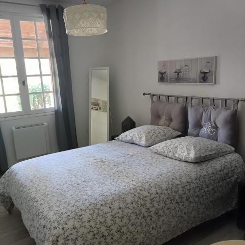 a bedroom with a bed and a window at L'arbre Du Magnan - Gîte En Ardèche in Chandolas