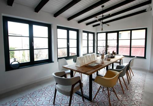 a dining room with a wooden table and chairs at The Pines Boutique Villa in Braşov