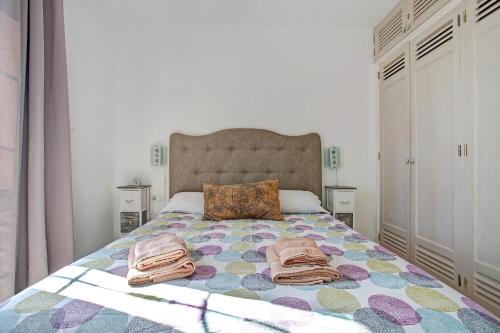 a bedroom with a bed with towels on it at Puerto Chico P in Playa Blanca