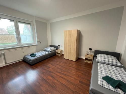 a living room with two beds and a couch at Das grüne Haus in Finsterwalde