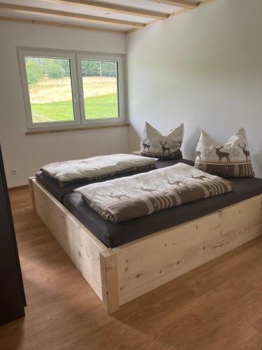 two twin beds in a room with a window at Ferienhaus am Kapellenhof in Triberg