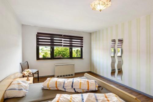 a bedroom with two beds and a window at Ferienwohnung Wallisch in Schotten