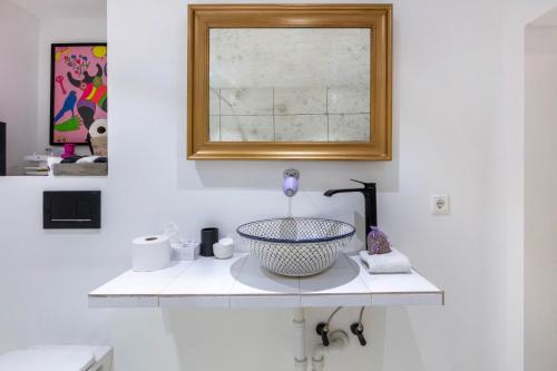 a white bathroom with a sink and a mirror at Ferienwohnung auf dem Wald 4 Per in Görwihl