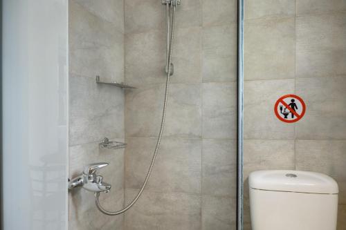 a shower stall with a toilet in a bathroom at Thea home Symi in Symi
