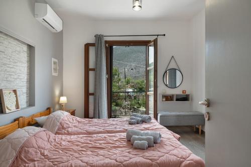 a bedroom with two beds with stuffed animals on them at Thea home Symi in Symi