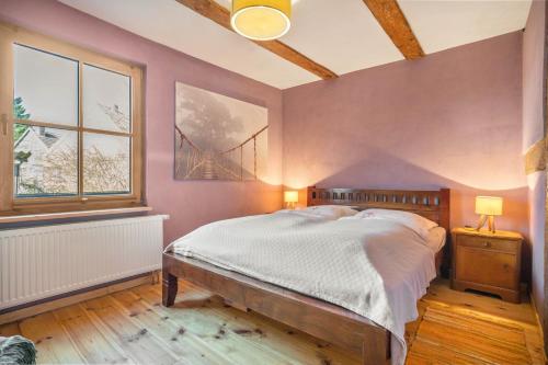 a bedroom with a bed and a bridge painting on the wall at Kleiner Eselhof in Semlow