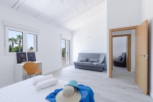 a room with a bed with a person in a blue robe at Blue Haven by Fidalsa in Catral