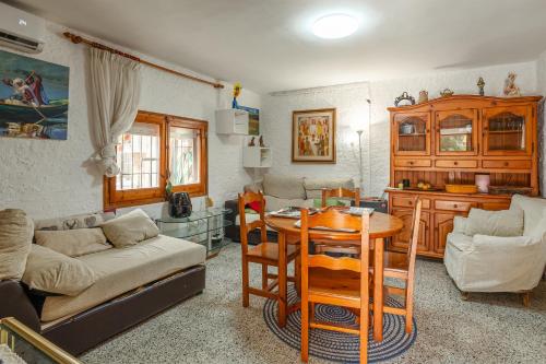 a living room with a table and a kitchen at Gesgroup in Lloret Blau