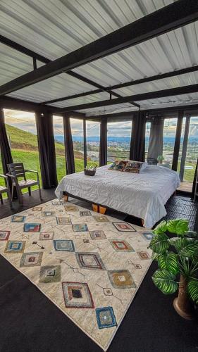a bedroom with a bed and a large rug at Ecoparque Hotel El Cielo Cabañas in Carmen de Viboral