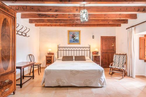 a bedroom with a bed and a table and chairs at Son Galileu in Llucmajor
