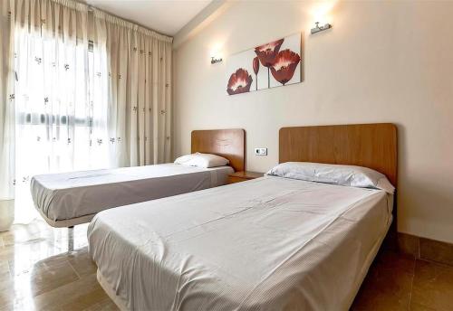 a bedroom with two beds and a window at Villa in Amarilla Golf in San Miguel de Abona