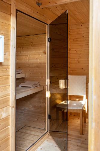 a sauna with a bench in a wooden cabin at Ferienhof Harrsen in Pellworm