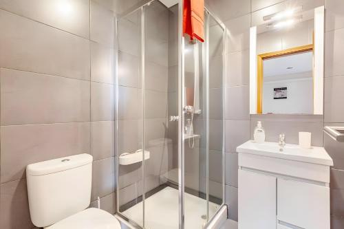 a white bathroom with a toilet and a sink at Casa de Balinhas - Gerês in Ventosa