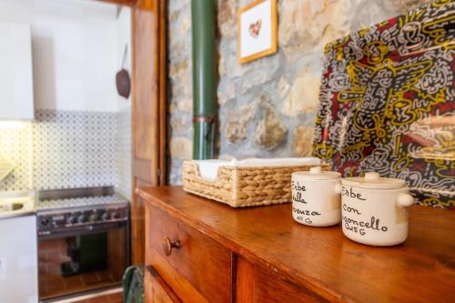 a kitchen with a counter with two cups on it at Birbina - Poggio alle Birbe in Il Bagno