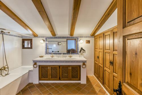 a bathroom with a tub and a sink and a bath tub at Can Palau in Agullana
