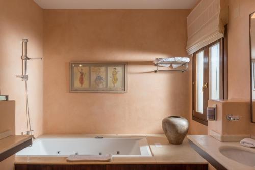a bathroom with a bath tub and a sink at Luxury Villa Malva in Benalup Casas Viejas