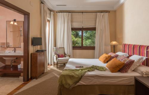 a hotel room with a bed and a sink at Luxury Villa Malva in Benalup Casas Viejas