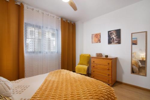 a bedroom with a bed and a dresser and a window at Ria Formosa Pool Heaven in Olhão