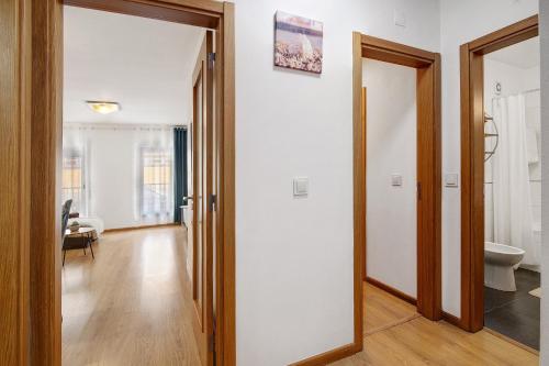 a hallway with a door leading to a bathroom at Ria Formosa Pool Heaven in Olhão
