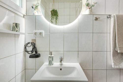 a white bathroom with a sink and a mirror at Sonnenpark 44 in Roding
