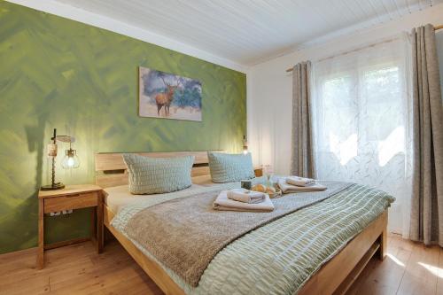 a bedroom with a bed with towels on it at Sonnenpark 44 in Roding