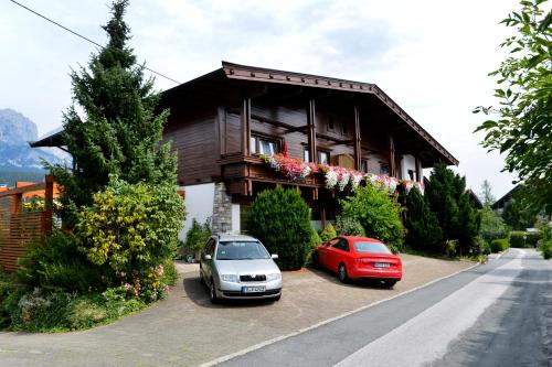 two cars parked in front of a house at Haus Friederike - Sylvia Brunner in Ellmau