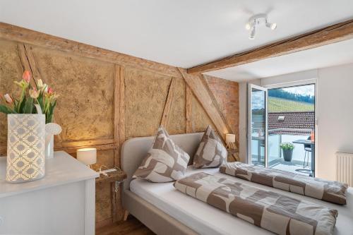 a living room with a couch and a window at Erlebnis-Bauernhof Scheunenglück in Oberkirch