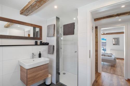 a white bathroom with a sink and a shower at Erlebnis-Bauernhof Scheunenglück in Oberkirch